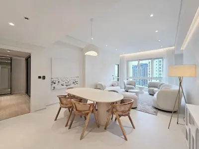 a white living room with a table and chairs at Marina Residence 5, Palm Jumeirah - Mint Stay in Dubai