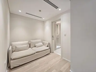 a white living room with a couch in a room at Marina Residence 5, Palm Jumeirah - Mint Stay in Dubai