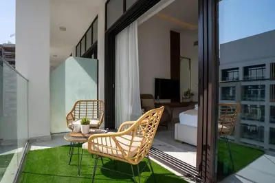 a patio with chairs and a table on a balcony at Airstay - Chic Studio in Meydan Azizi 65 - Monthly Offer Available in Dubai