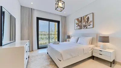 a bedroom with a bed and a large window at Stylish 1 Bedroom in Viridian City Walk in Dubai