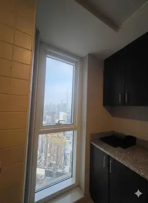 a window in a kitchen with a view of a city at Luxury 2BR with Maid Burj Khalifa and Canal View in Dubai