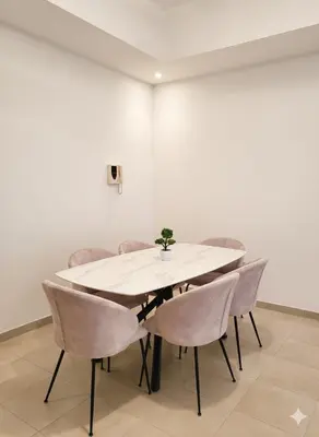 a dining room with a white table and chairs at Luxury 2BR with Maid Burj Khalifa and Canal View in Dubai