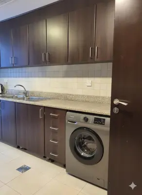 a kitchen with a washing machine and a sink at Luxury 2BR with Maid Burj Khalifa and Canal View in Dubai