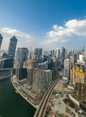 an aerial view of a city with skyscrapers at Luxury 2BR with Maid Burj Khalifa and Canal View in Dubai