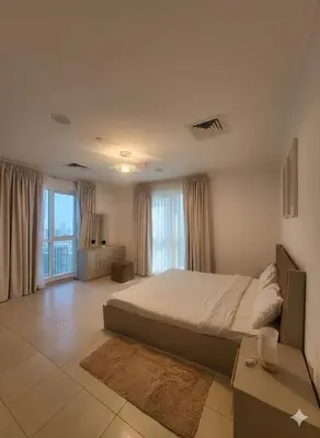 a bedroom with a large bed and a large window at Luxury 2BR with Maid Burj Khalifa and Canal View in Dubai