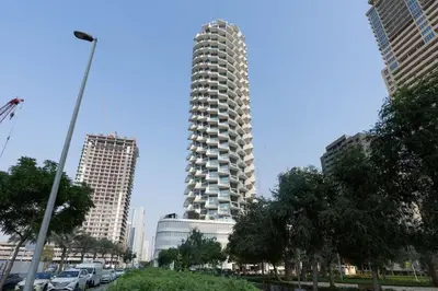 a tall building in the middle of a city at Calm Luxe 1BR Suite in Binghatti Royale with Parking! in Dubai
