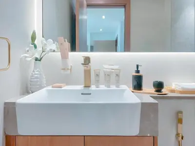 a bathroom with a white sink and a mirror at Warm Minimal 1BR in Binghatti Tulip with Free Parking! in Dubai