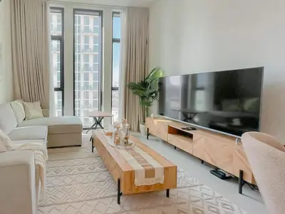 a living room with a large flat screen tv at Warm Minimal 1BR in Binghatti Tulip with Free Parking! in Dubai