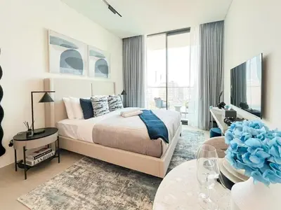 a bedroom with a bed and a living room at Binghatti Azure Ethereal Studio Haven with Pool & Gym! in Dubai