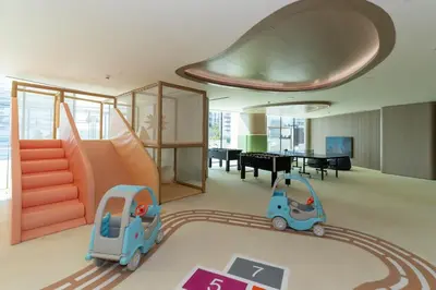 a childs room with a slide and a toy car at Calm 1BR Haven with Private Pool in Binghatti Royale in Dubai