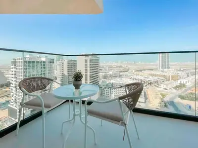 a table and chairs on a balcony with a view at Calm 1BR Haven with Private Pool in Binghatti Royale in Dubai