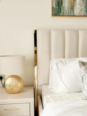 a bedroom with a bed with a pillow and a lamp at Softline Studio with Open Views in Binghatti Phoenix! in Dubai