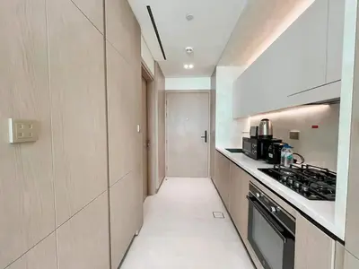 a kitchen with a long hallway with a stove at Softline Studio with Open Views in Binghatti Phoenix! in Dubai