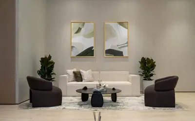a living room with a white couch and two chairs at Binghatti Phantom's Elegant 1BR with Private Pool! in Dubai
