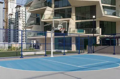 a basketball court in front of a building at Binghatti Phantom's Elegant 1BR with Private Pool! in Dubai