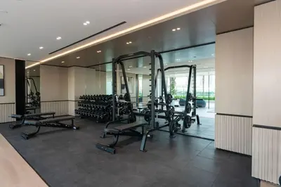 a gym with treadmills and exercise equipment in a building at Elevated Studio Living at Binghatti Phoenix in Dubai