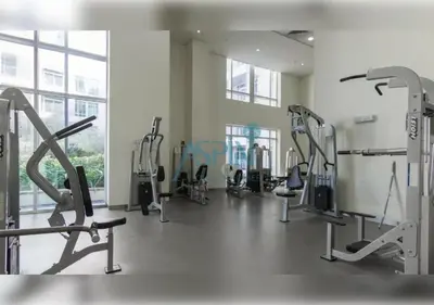 a gym with treadmills and machines in a room at Aspin Brand New Premium Studio with Pool View - Burj Views in Dubai