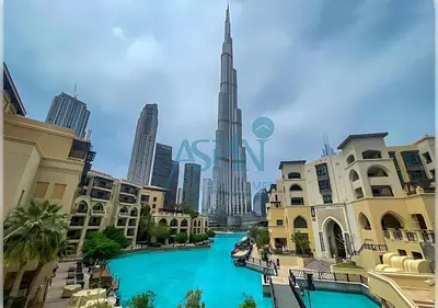 a river in the middle of a city with tall buildings at Aspin Brand New Premium Studio with Pool View - Burj Views in Dubai
