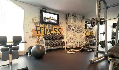 a fitness room with a gym with a television and weights at Dubai Marina Penthouse Suite - Prime Location in Dubai