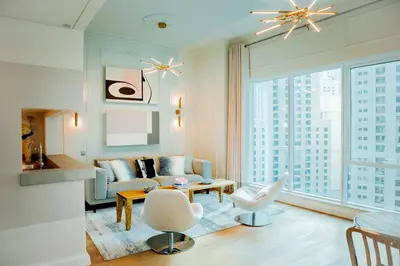 a living room with a couch and a chair at Dubai Marina Penthouse Suite - Prime Location in Dubai