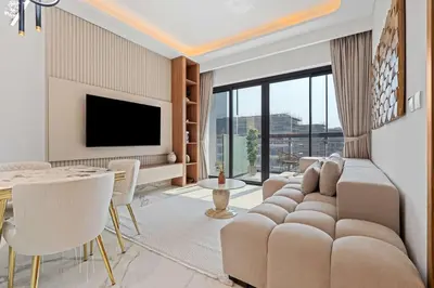 a living room with a couch and a tv at Modern 1BR Apartment w Balcony in Meydan in Dubai