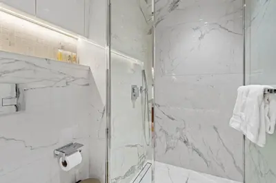 a bathroom with a shower with a glass door at Modern 1BR Apartment w Balcony in Meydan in Dubai