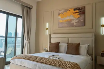 a bedroom with a bed with a teddy bear on it at Werova - Urban Living 1BR Apartment in JVC in Dubai