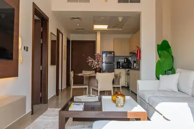 a living room with a couch and a table at Werova - Urban Living 1BR Apartment in JVC in Dubai