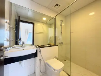 a bathroom with a sink and a toilet and a shower at Werova - Urban Living 1BR Apartment in JVC in Dubai