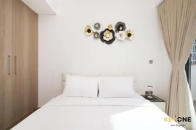 a bedroom with a white bed and a window at Stylish Riviera Studio Near Downtown in Dubai