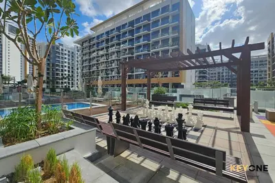 a chess game on a bench in front of a building at Stylish Riviera Studio Near Downtown in Dubai