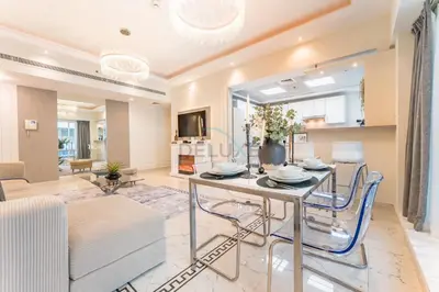 a dining room and living room with a table and chairs at Minutes from Marina Promenade, Surrounded by Shops, and a Short Drive to Ain Dubai, Opal Tower, Dubai Marina by Deluxe Holiday Homes in Dubai