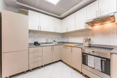 a kitchen with white cabinets and a sink at Minutes from Marina Promenade, Surrounded by Shops, and a Short Drive to Ain Dubai, Opal Tower, Dubai Marina by Deluxe Holiday Homes in Dubai