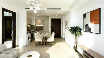 a dining room and kitchen with a table and chairs at Sohba Creek Vistas Luxury 2 Bedroom with Free Parking in Downtown Dubai Near Burj Khalifa in Dubai