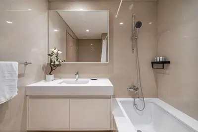 a bathroom with a sink and a tub and a mirror at Iconic Burj Views l Elegant 2BR at Burj Royale in Dubai