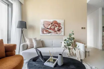 a living room with a white couch and a table at Iconic Burj Views l Elegant 2BR at Burj Royale in Dubai