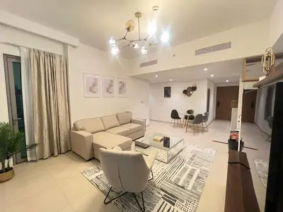 a living room with a couch and chairs at BAZ HOMES - Burj Khalifa View 2BR Connected to Dubai Mall in Dubai