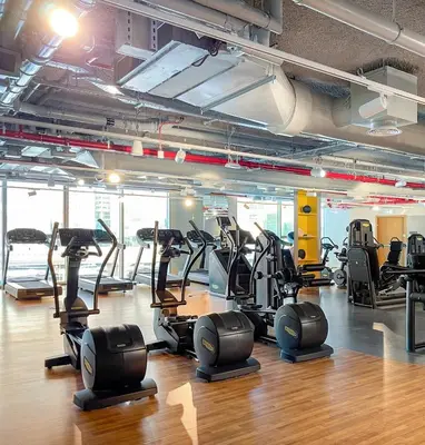 a gym with several treadmills and elliptical machines at BAZ HOMES - Burj Khalifa View 2BR Connected to Dubai Mall in Dubai
