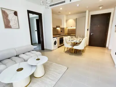 a living room with a couch and a table at Sohba Creek Vistas Luxury 2 Bedroom with Free Parking in Downtown Dubai Near Burj Khalifa in Dubai