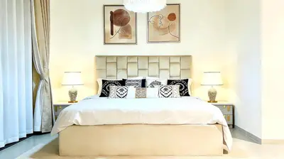 a bedroom with a large white bed with two lamps at Sohba Creek Vistas Luxury 2 Bedroom with Free Parking in Downtown Dubai Near Burj Khalifa in Dubai