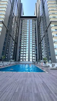 a swimming pool in the middle of two tall buildings at Sohba Creek Vistas Luxury 2 Bedroom with Free Parking in Downtown Dubai Near Burj Khalifa in Dubai
