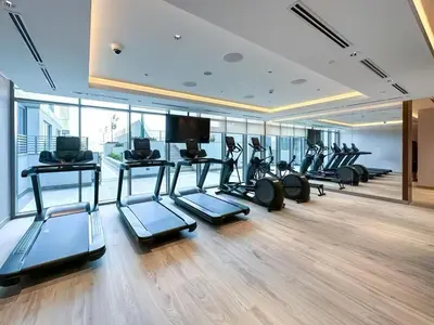 a gym with a row of treadmills and elliptical machines at Sohba Creek Vistas Luxury 2 Bedroom with Free Parking in Downtown Dubai Near Burj Khalifa in Dubai