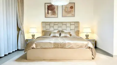 a bedroom with a large bed with two lamps at Sohba Creek Vistas Luxury 2 Bedroom with Free Parking in Downtown Dubai Near Burj Khalifa in Dubai