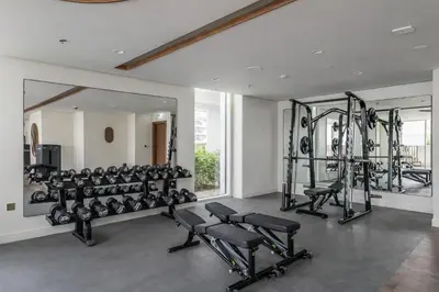 a gym with several treadmills and weights at 2BR Beachfront Apartment at Palace Beach Residence in Dubai
