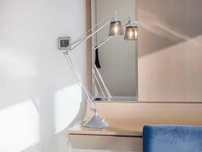 a lamp sitting on a table next to a mirror at Spacious 3BR in Paramount Tower Luxury Living in Dubai