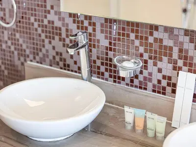 a bathroom with a white sink and a mirror at Spacious 3BR in Paramount Tower Luxury Living in Dubai