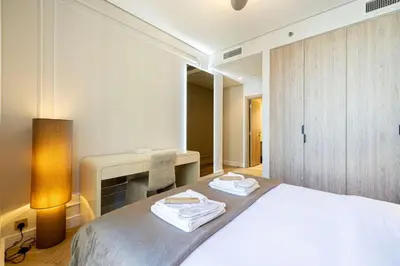 a bedroom with a bed with two towels on it at Brand New Exclusive 2BR, Burj and Canal View in Dubai