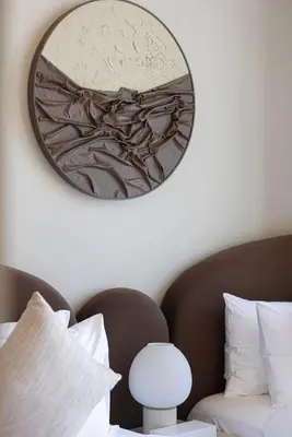 a mirror on a wall above a bed with a bed sidx sidx sidx at Brand New Exclusive 2BR, Burj and Canal View in Dubai