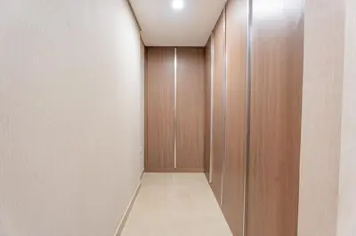 a corridor with wooden doors and a hallway with a floor at Premium 1BR King Bed Dubai Healthcare City in Dubai