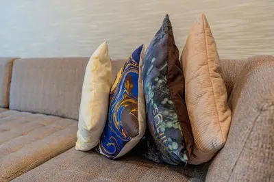 three pillows sitting on the back of a couch at Premium 1BR King Bed Dubai Healthcare City in Dubai